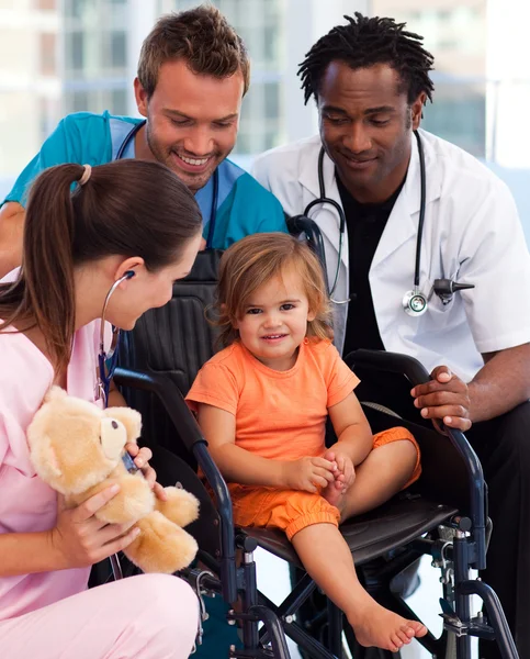 Portrait of a little patient with medical team — Stock Photo, Image