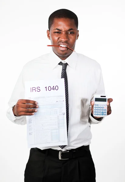 Angry businessman holding a sheet and a calculator — Stock Photo, Image