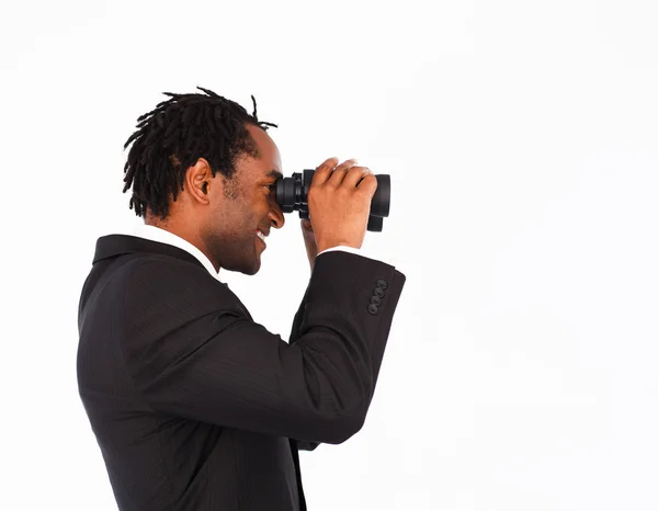 Afro-american businessman searching for something with binoculars — Stock Photo, Image