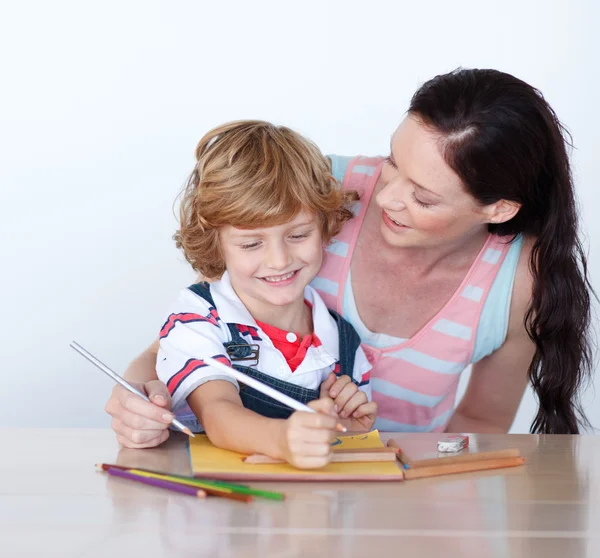 Positive mother and son doing homework together — Stock Photo, Image