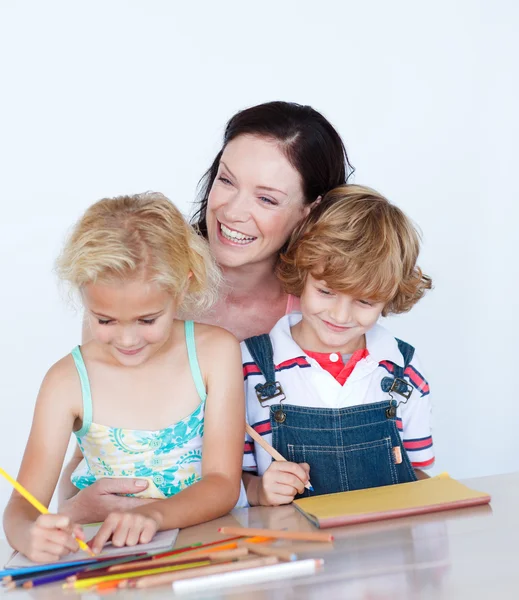 Children doing homework with their mother — Stock Photo, Image