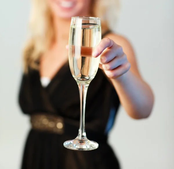 Zbliżenie: kobieta trzyma kieliszek z szampanem skupić się na szampana — Zdjęcie stockowe