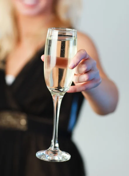 Primer plano de una joven sosteniendo una copa de champán enfocada en el champán — Foto de Stock