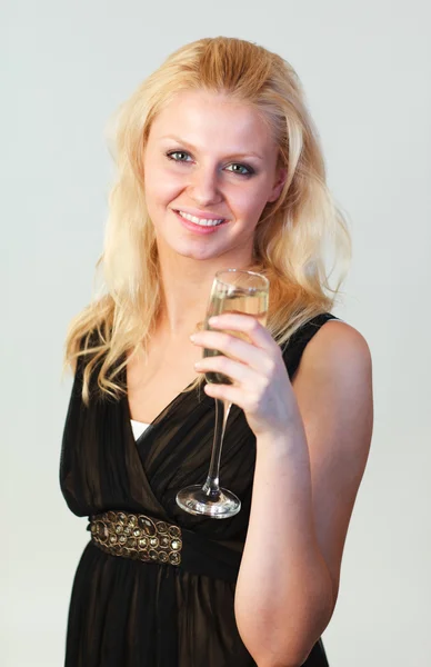 Attractive woman holding a glass of champagne focus on woman — Stock Photo, Image