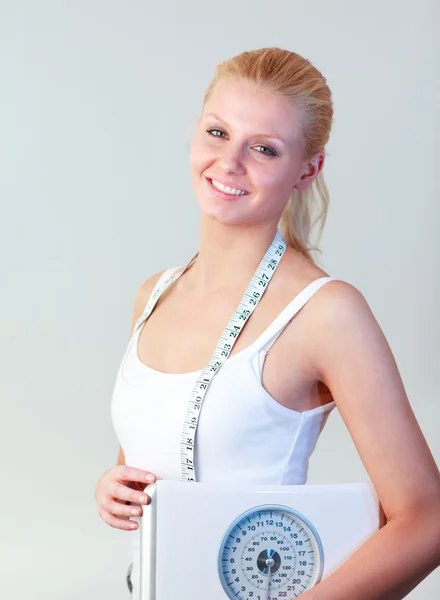 Beautiful woman holding a scales focus on woman — Stock Photo, Image