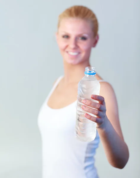 Beautiful woman with a bottle of water with focus on water — Stock Photo, Image