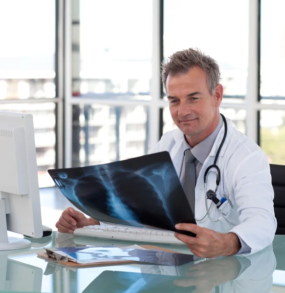 stock image Good-looking male doctor examining a x-ray