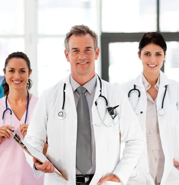 Senior Smiling doctor with his colleagues — Stock Photo, Image