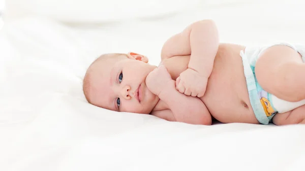 Beautiful baby lying in bed — Stock Photo, Image