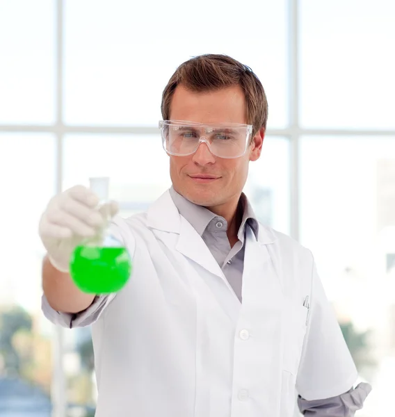 Young scientist examining a test-tube — Stock Photo, Image