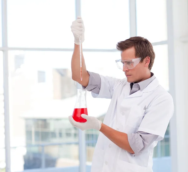 Scientist examinig a test-tube — Stock Photo, Image