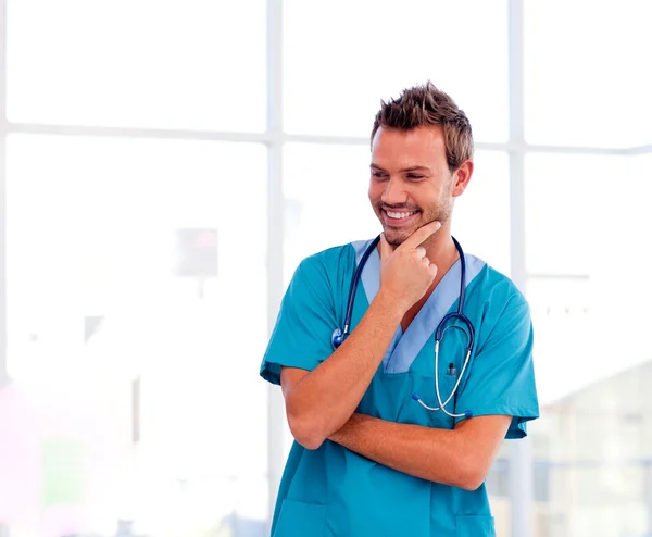 Smiling young doctor isolated in hospital — Stock Photo, Image