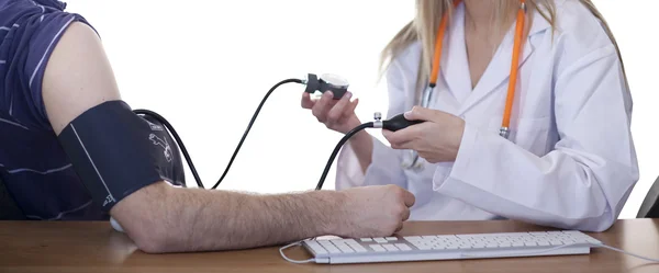 Doctor measuring blood pressure of a patient — Stock Photo, Image