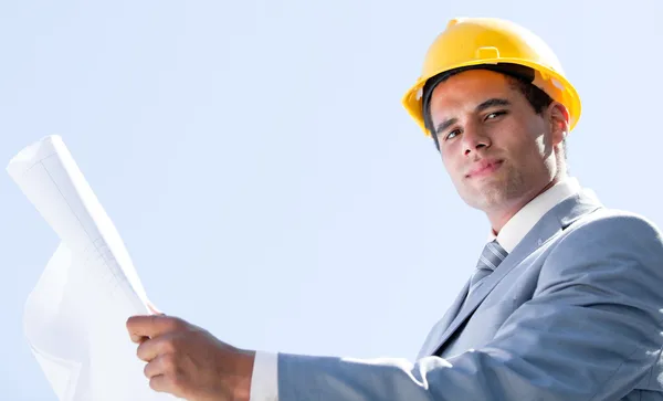 Smiling male architect holding a blueprint — Stock Photo, Image