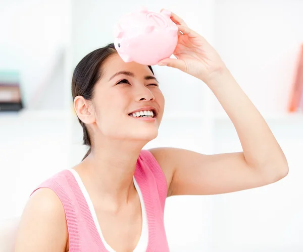 stock image Portrait of a smiling businesswoman holding a piggy-bank