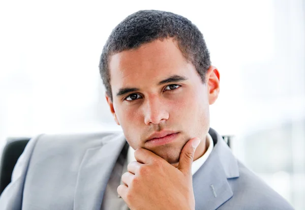 Portrait of a pensive latin businessman sitting at his desk — Stock Photo, Image