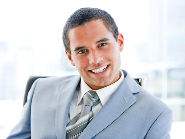 Attractive young businessman sitting at his desk — Stock Photo, Image