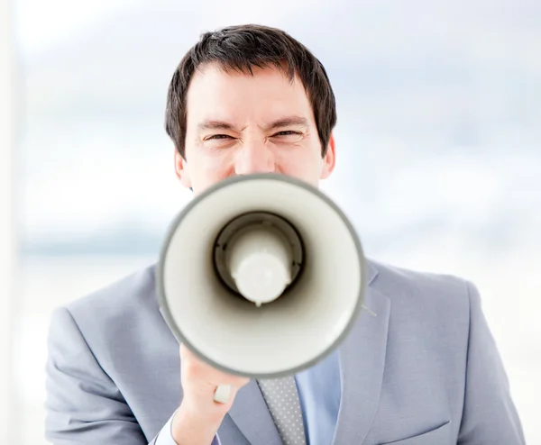 Portrait of an stressed businessman using a megaphone — Stock Photo, Image