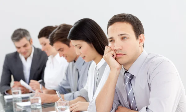 Attractive businessman bored at a presentation — Stock Photo, Image