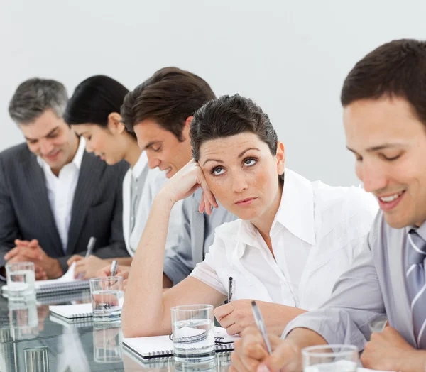 Brunette businesswoman bored in a meeting — Stock Photo, Image
