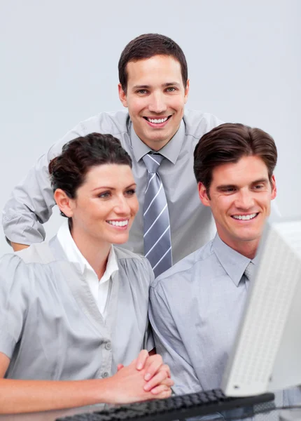 Positive businessteam working at a computer — Stock Photo, Image