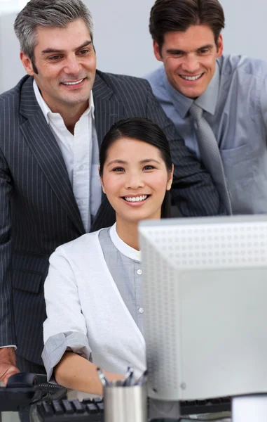 Positive business working together at a computer — Stock Photo, Image