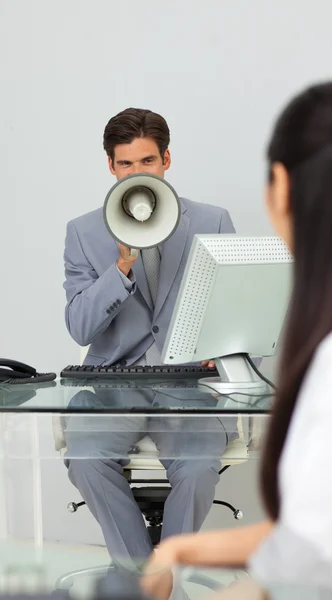 Empresário dando instruções com um megafone — Fotografia de Stock
