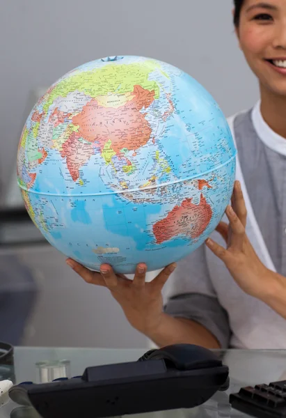 Close-up of an asian businesswoman holding terrestrial globe — Stock Photo, Image