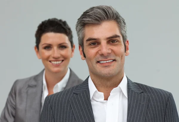Smiling business associates in a row — Stock Photo, Image
