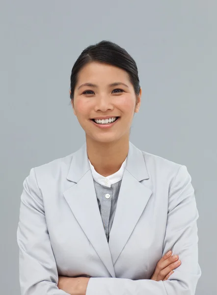Smiling businesswoman with folded arms — Stock Photo, Image