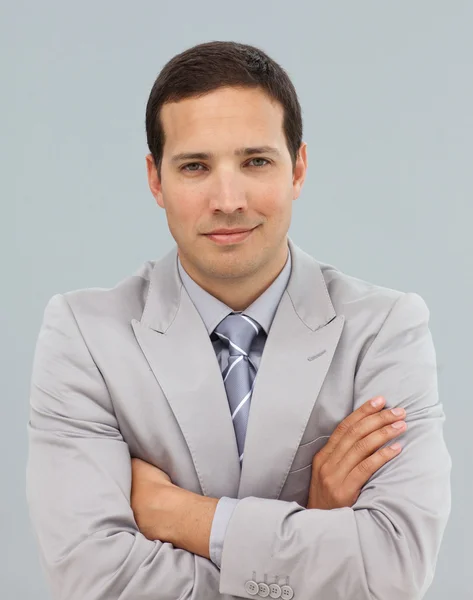 Young businessman with folded arms in front of the camera — Stock Photo, Image