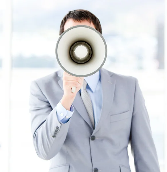 Portrait of an young businessman using a megaphone — Stock Photo, Image