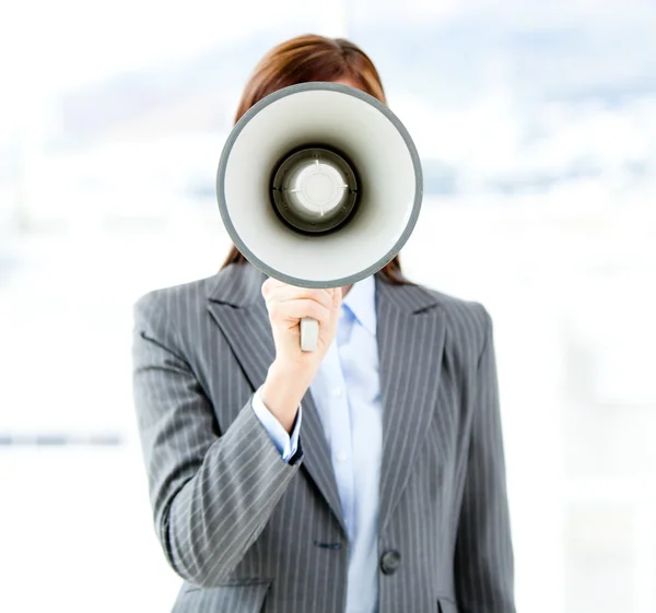 Portrait of an confident businesswoman using a megaphone — Stock Photo, Image