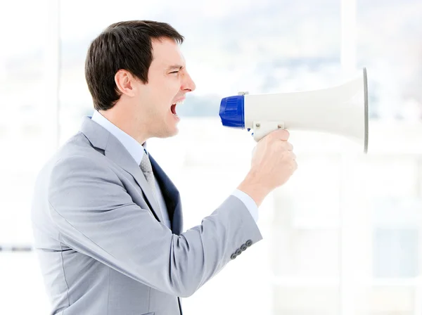 Portrait of an pretty businessman using a megaphone — Stock Photo, Image