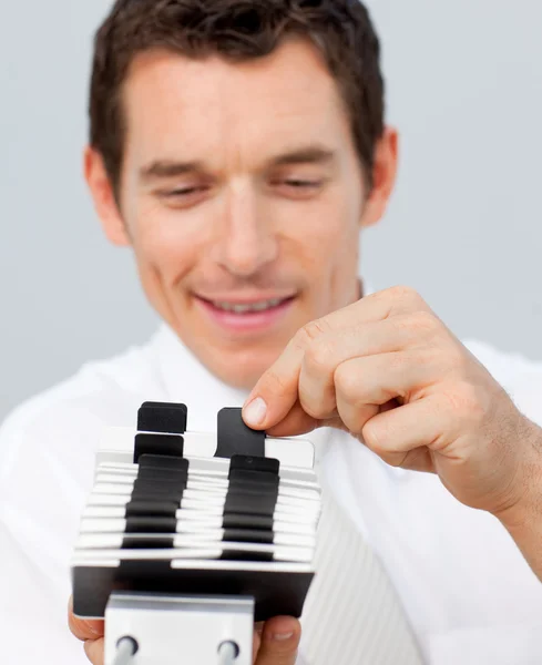 Close-up of a businessman consulting a card holder — Stock Photo, Image