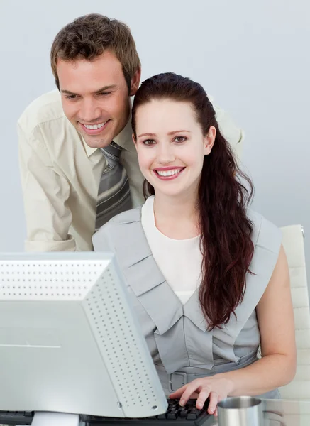 Beautiful businesswoman and attractive businessman using a compu — Stock Photo, Image