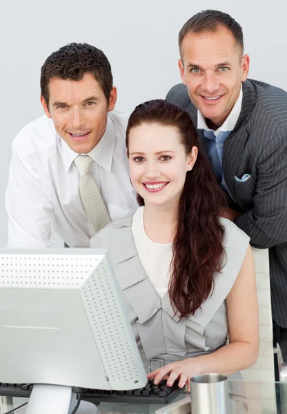 Smiling three business using a computer — Stock Photo, Image