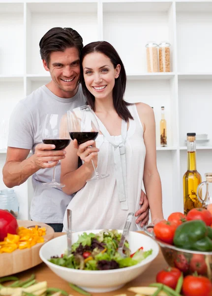 Smiling couple toasting and cooking — Stock Photo, Image