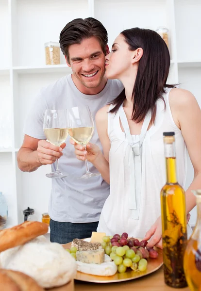 Woman kissing her boyfriend and toasting with white wine — Stock Photo, Image