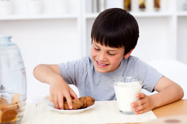 Little boy eating cookies — Stock Photo, Image