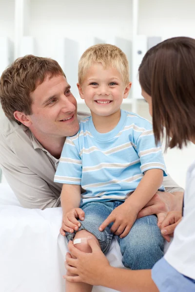 stock image Little boy with scratched knee with his father in tow