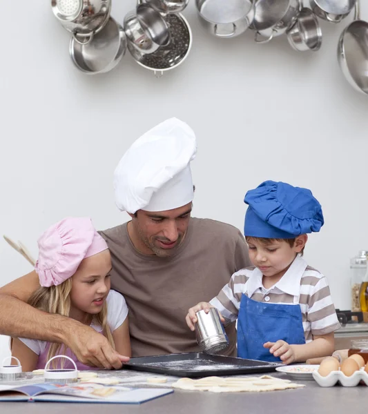 Vader bakken van koekjes met zijn kinderen — Stockfoto