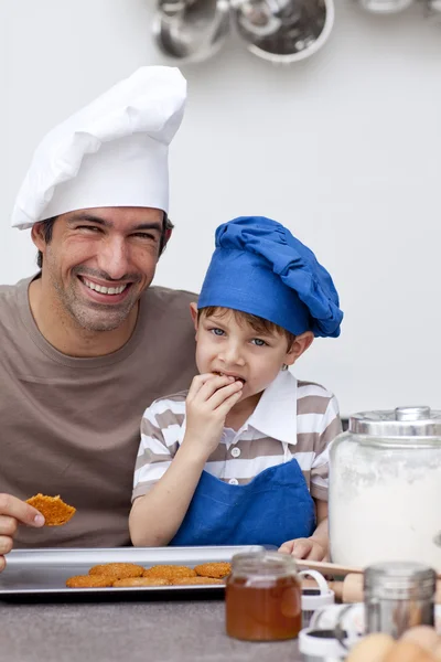 Vater und Sohn essen selbstgebackene Plätzchen — Stockfoto