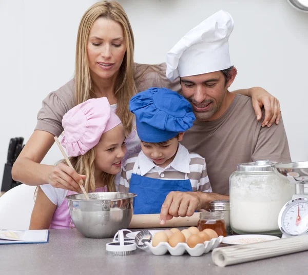 Kinderen bakken van koekjes met hun ouders — Stockfoto