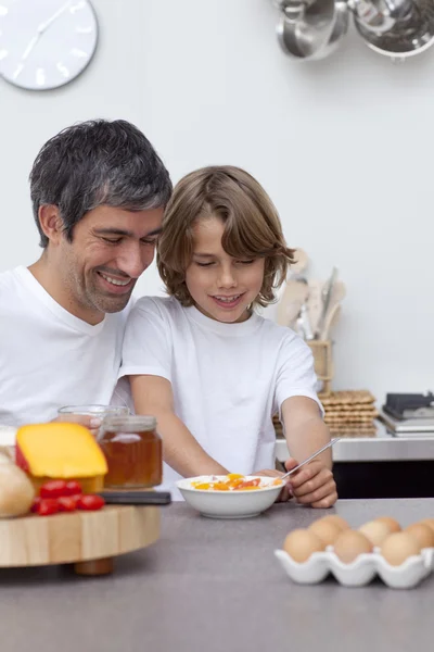 Sorrindo pai e filho tomando café da manhã juntos — Fotografia de Stock