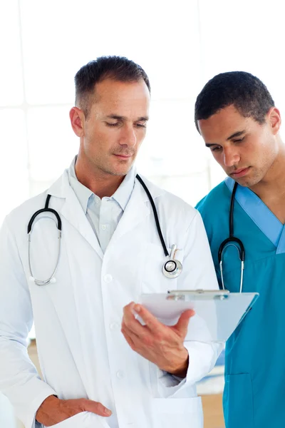 Dois médicos atraentes falando sobre um paciente — Fotografia de Stock