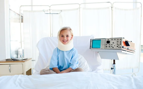 A patient with a neck brace sitting on a hospital bed — Stock Photo, Image