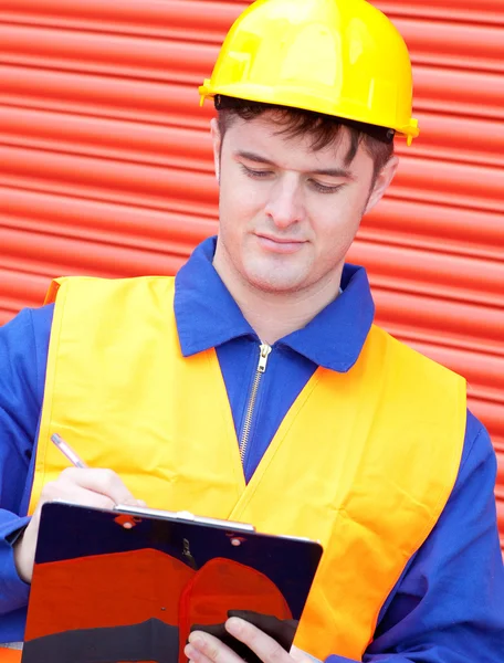 Mature male engineer writing his report — Stock Photo, Image