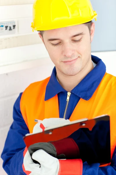 Confident electrician repairing a power plan — Stock Photo, Image