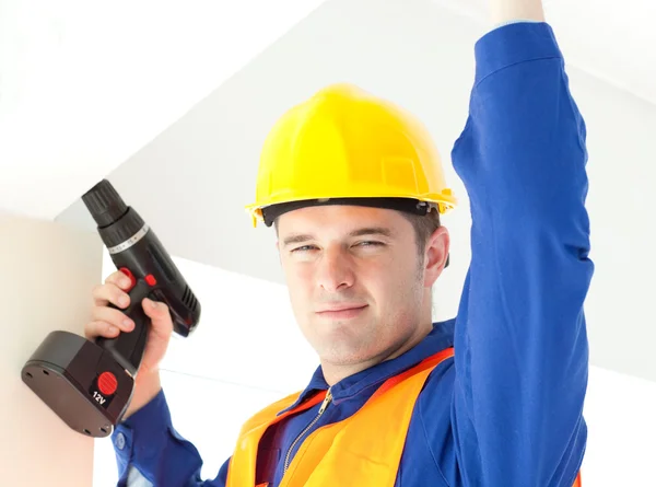 Joyful electrician repairing a power plan — Stock Photo, Image